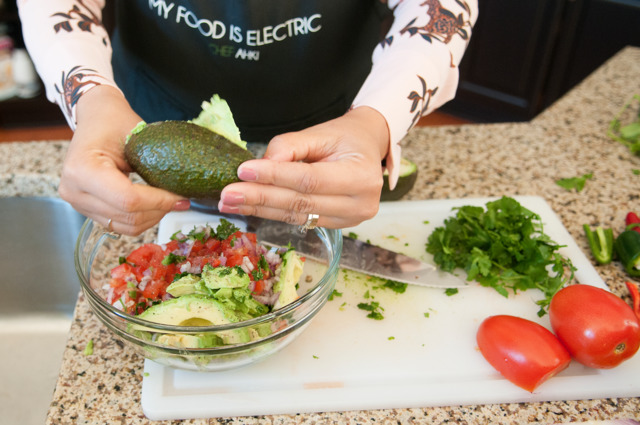 ALL ABOUT THAT GUAC: Chef Ahki adds avocado to a bowl of diced Roma tomatoes, red onion, cilantro and jalapeno.